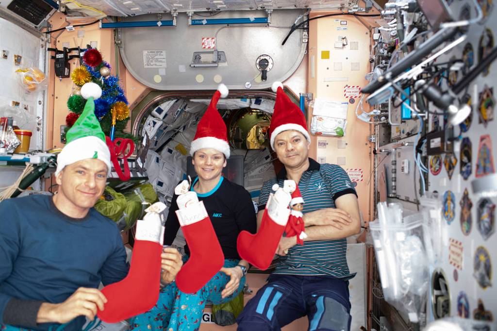 The Expedition 58 crew opens stockings on Christmas Day