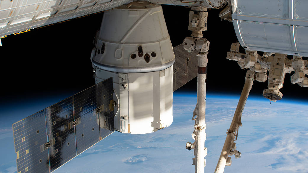 The SpaceX Dragon and the Canadarm2 above the Indian Ocean