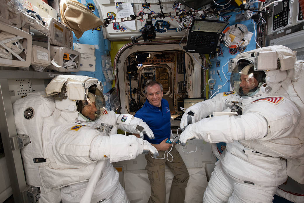 Astronaut David Saint-Jacques assists fellow astronauts Christina Koch and Nick Hague