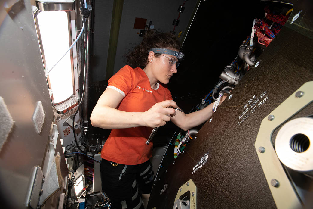 Flight Engineer Christina Koch removes audio hardware