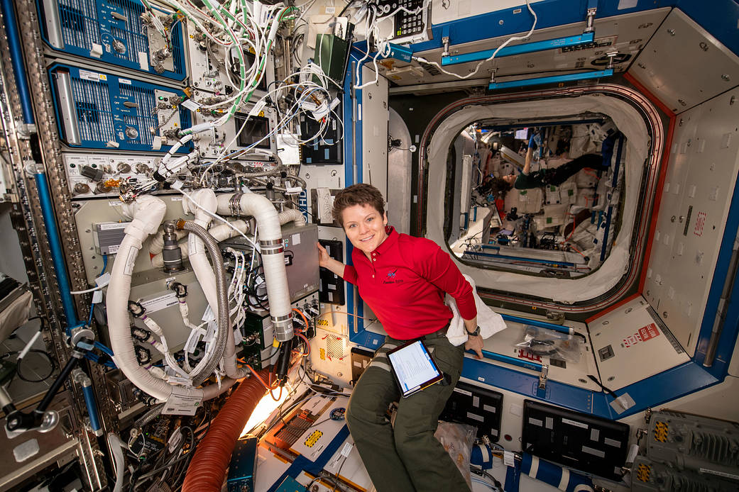 NASA astronaut Anne McClain installs the Thermal Amine Scrubber