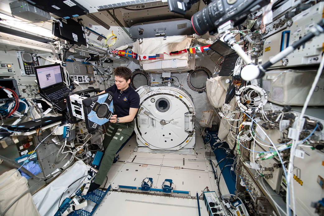 NASA astronaut Anne McClain performs the first series of tests of an Astrobee robot, Bumble, during a hardware checkout.