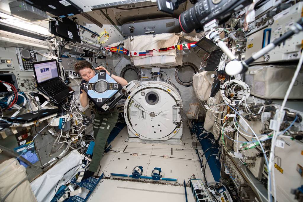Astronaut Anne McClain checks out the new Astrobee hardware