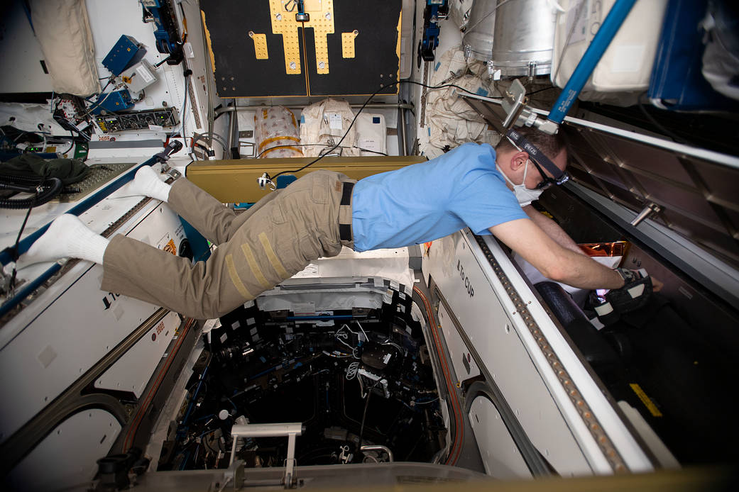NASA astronaut Nick Hague works on life support maintenance