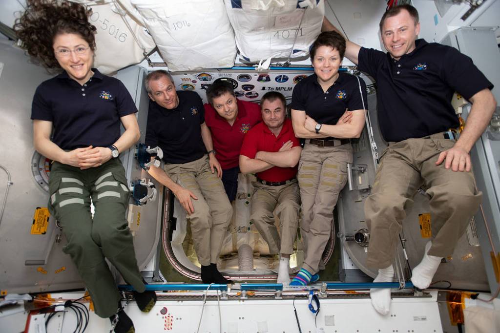 The six-member Expedition 59 crew gathers for a portrait