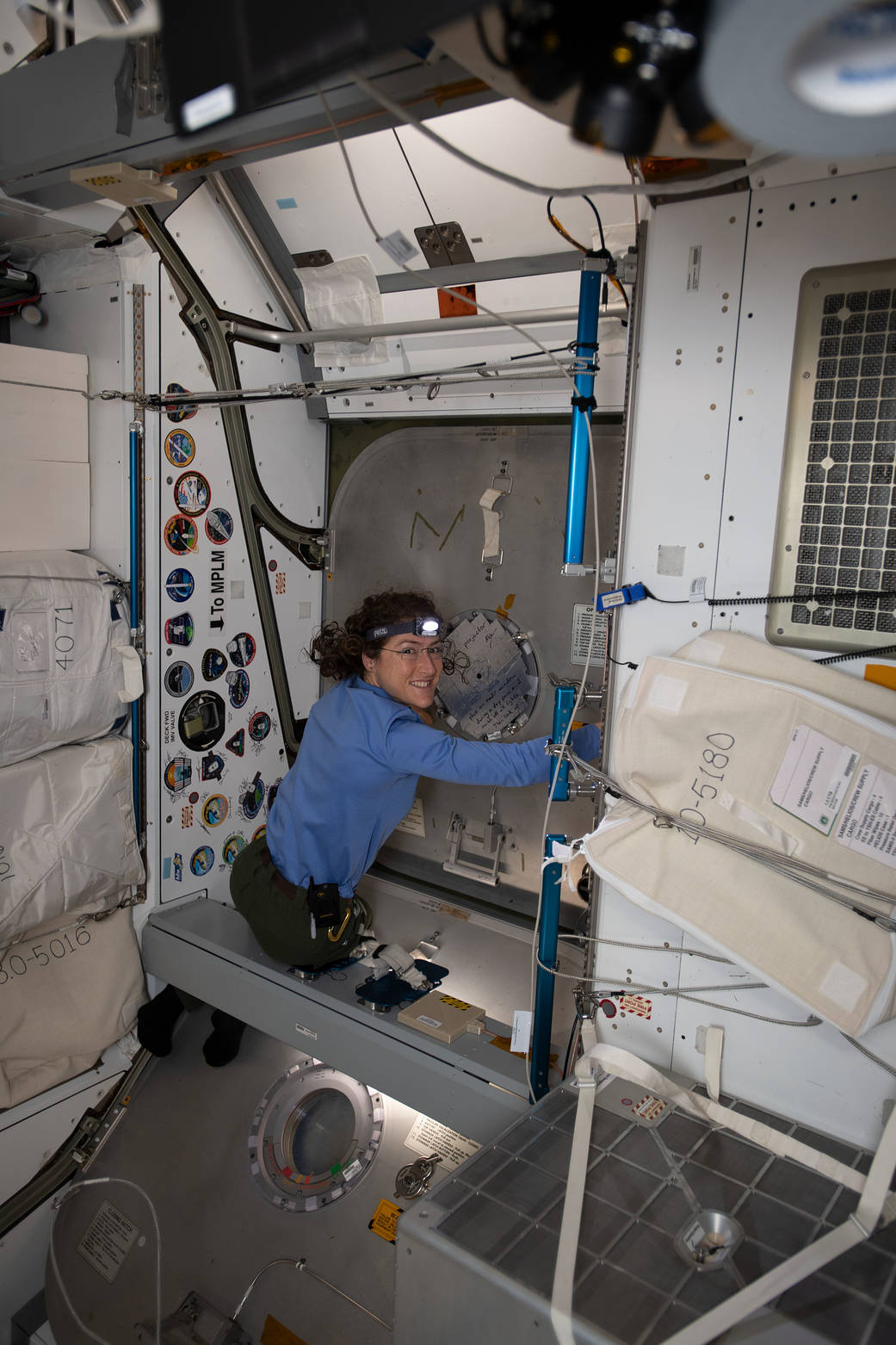 NASA astronaut Christina Koch closes the SpaceX Dragon Hatch