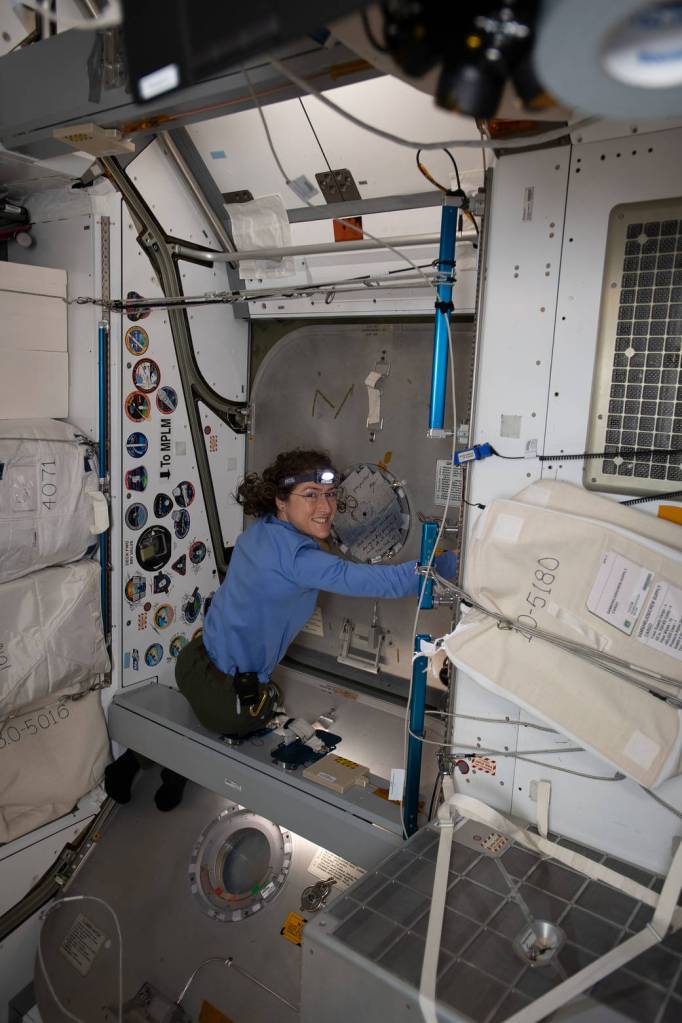 NASA astronaut Christina Koch closes the SpaceX Dragon Hatch