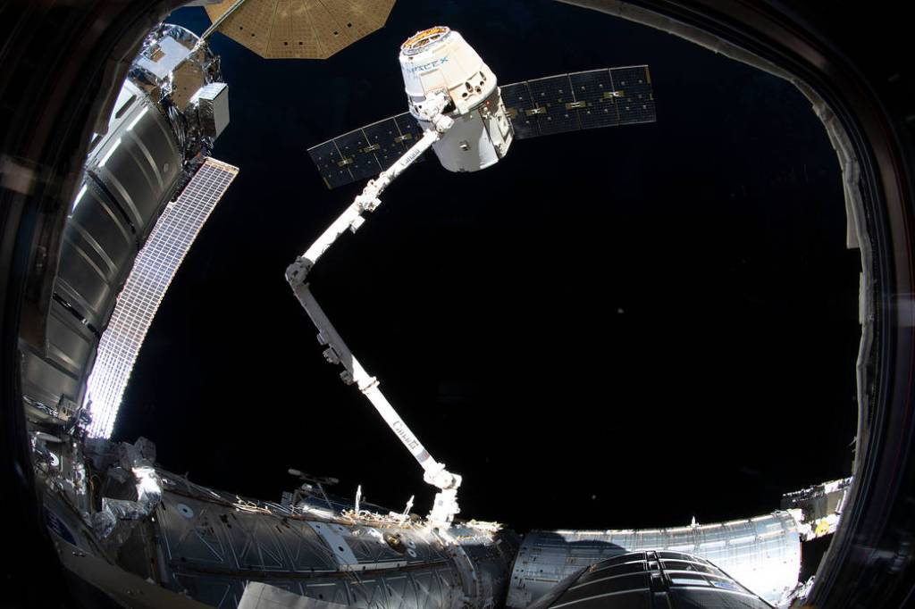 The SpaceX Dragon cargo craft in the grips of the Canadarm2