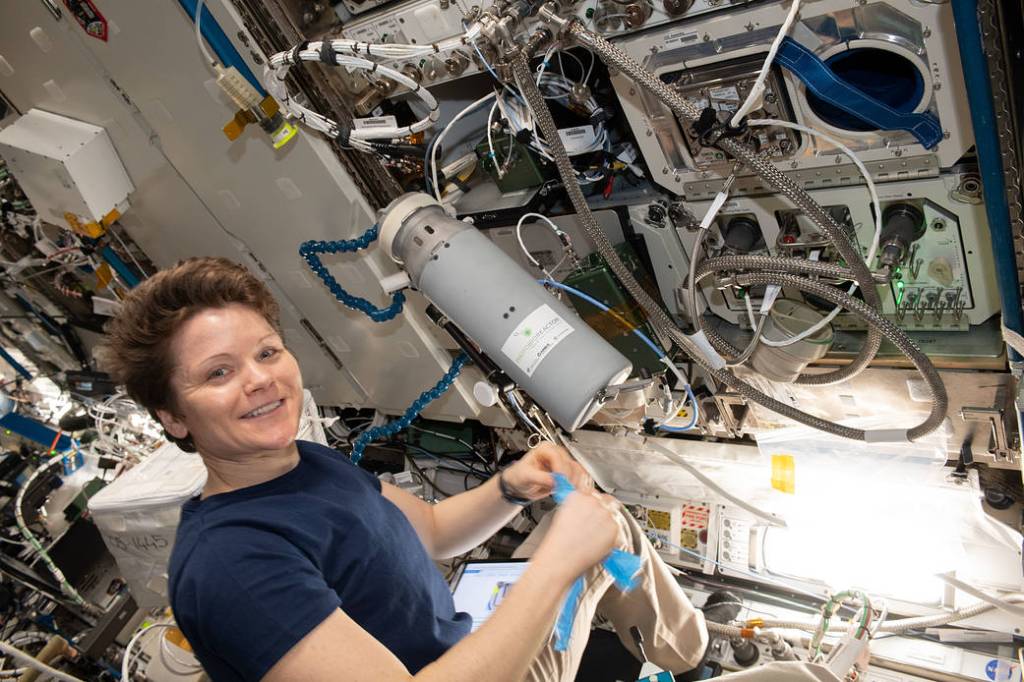 NASA astronaut Anne McClain works with Photobioreactor hardware