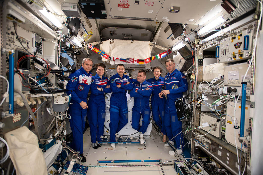 The six-member Expedition 59 crew gathers for a portrait