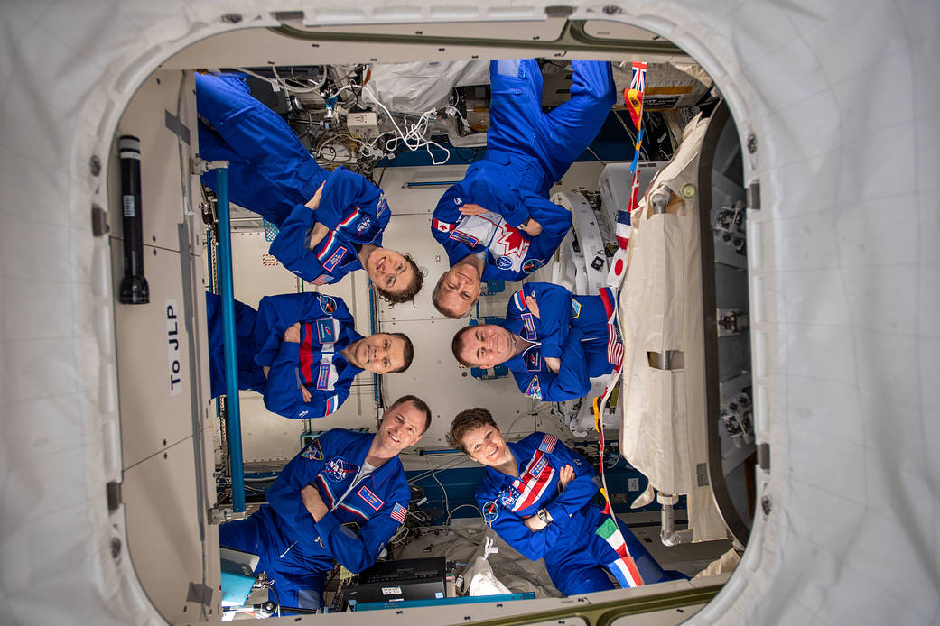 The six-member Expedition 59 crew gathers for a portrait