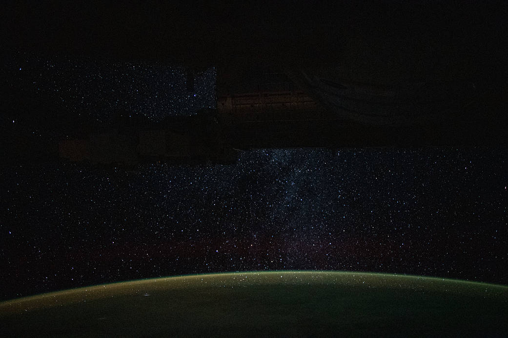 A starry nighttime background seemingly glitters down on Earth