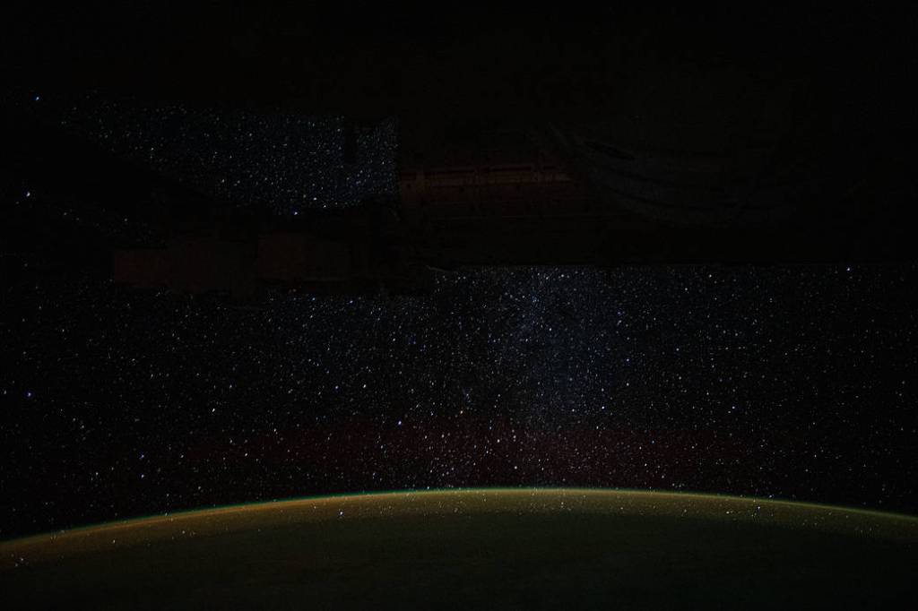 A starry Milky Way glitters above Earth