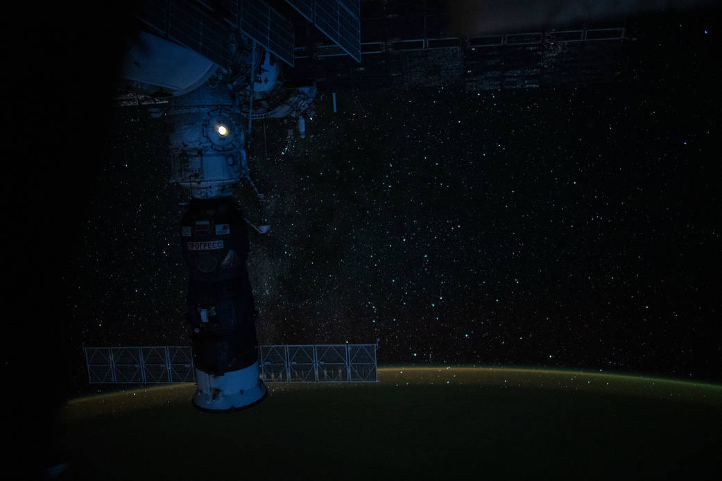 Earth's luminous atmospheric glow back-dropped by the tranquil Milky Way