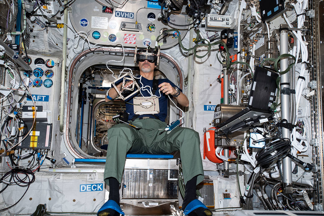 Flight Engineer Luca Parmitano is seated inside the Columbus laboratory module