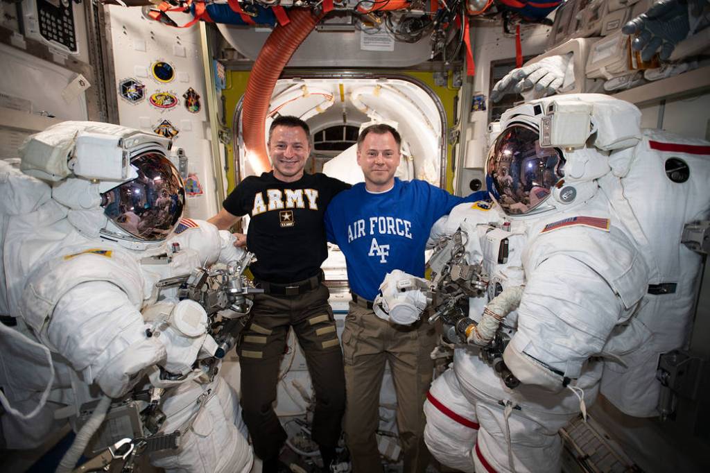 NASA astronauts Andrew Morgan and Nick Hague pose with their spacesuits
