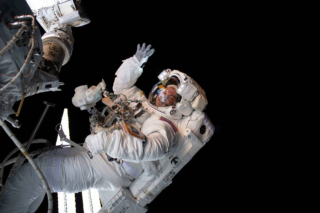 Astronaut Andrew Morgan waves during a spacewalk