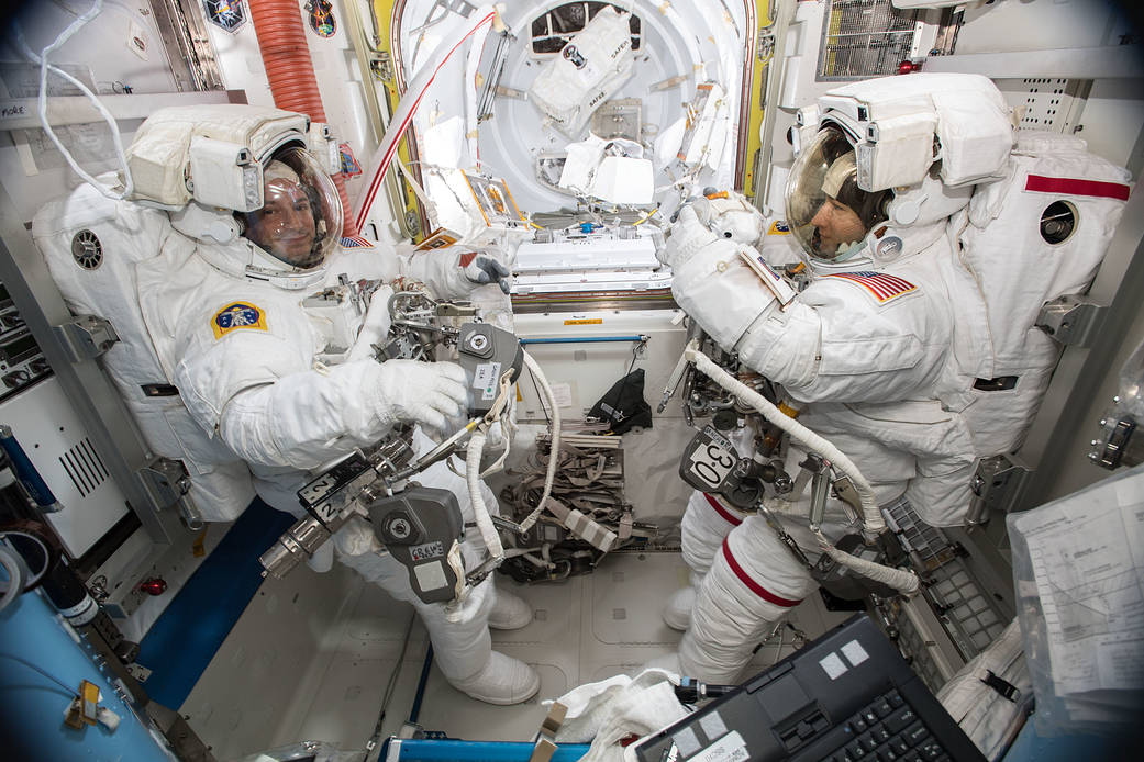 Astronauts Andrew Morgan and Christina Koch suited up in U.S. spacesuits