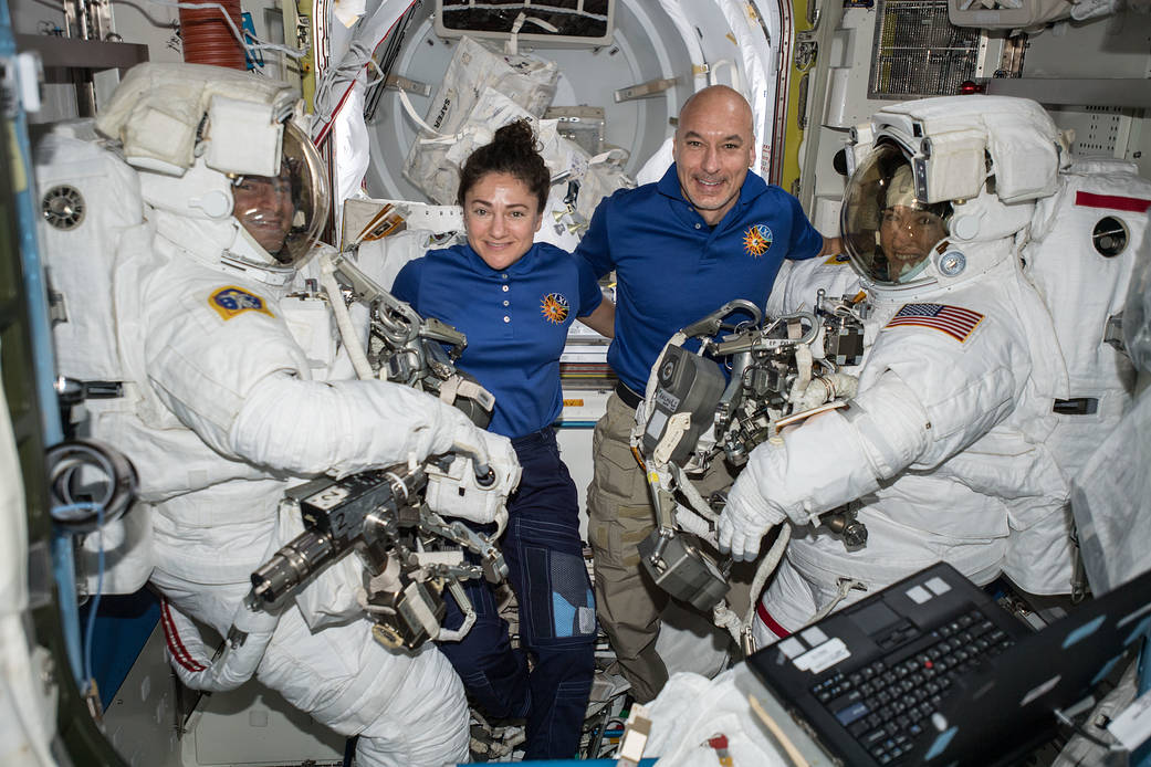 Astronauts assist spacewalkers in the Quest airlock