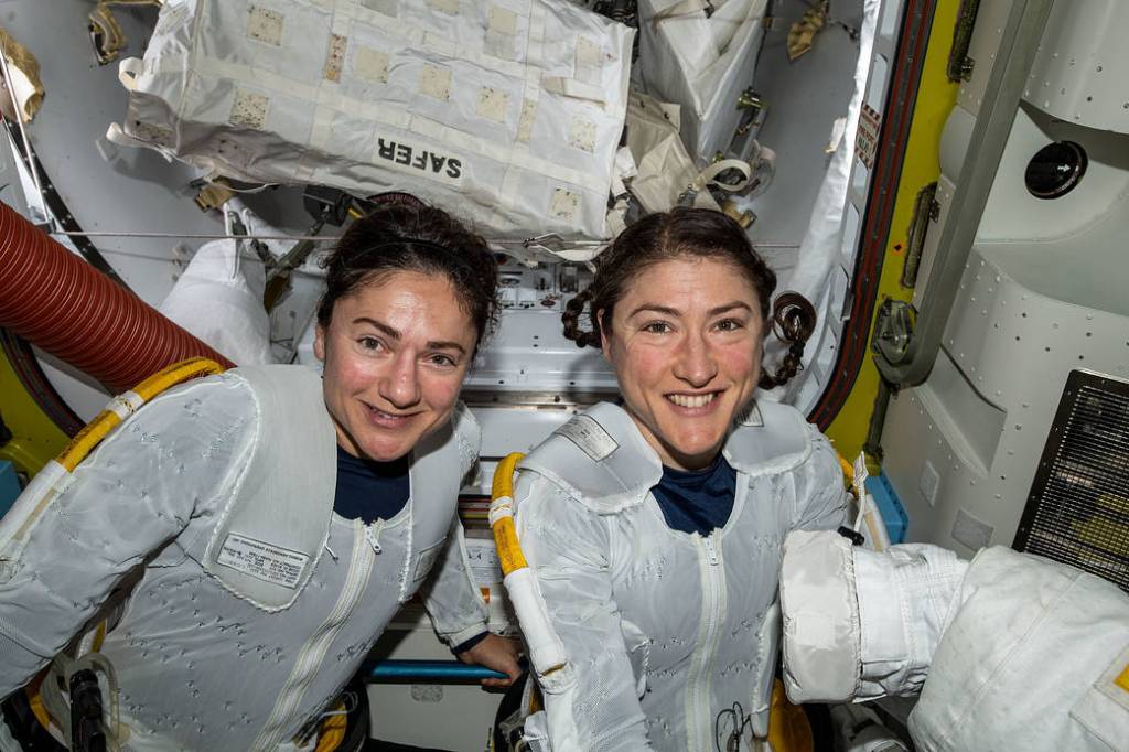 NASA astronauts Jessica Meir and Christina Koch put on their spacesuits as they prepare to leave the hatch of the space station