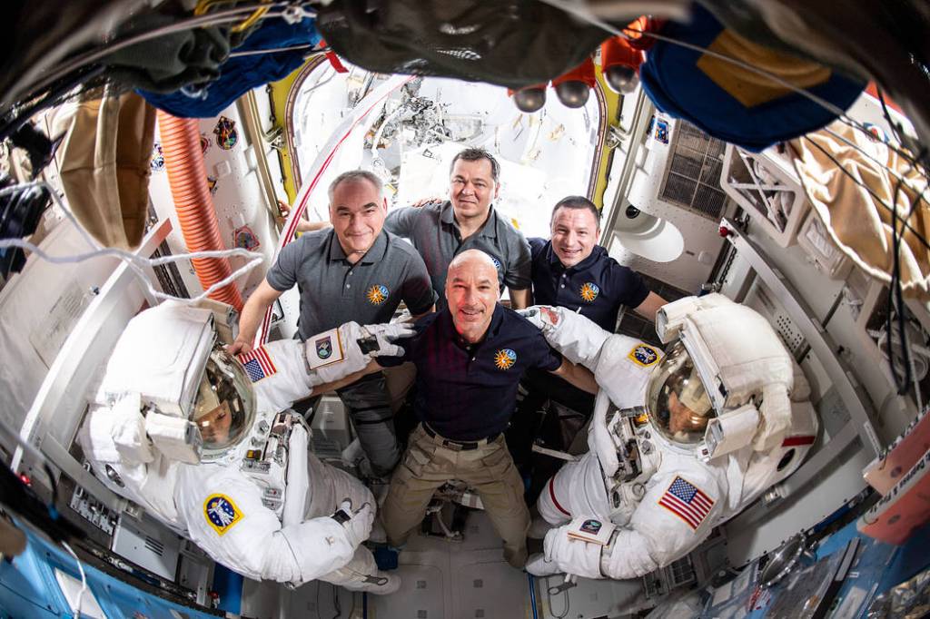 Spacewalkers Jessica Meir and Christina Koch pose with their Expedition 61 crewmates