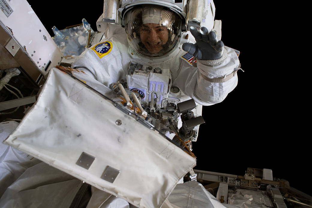 NASA astronaut Jessica Meir waves at the camera during a spacewalk