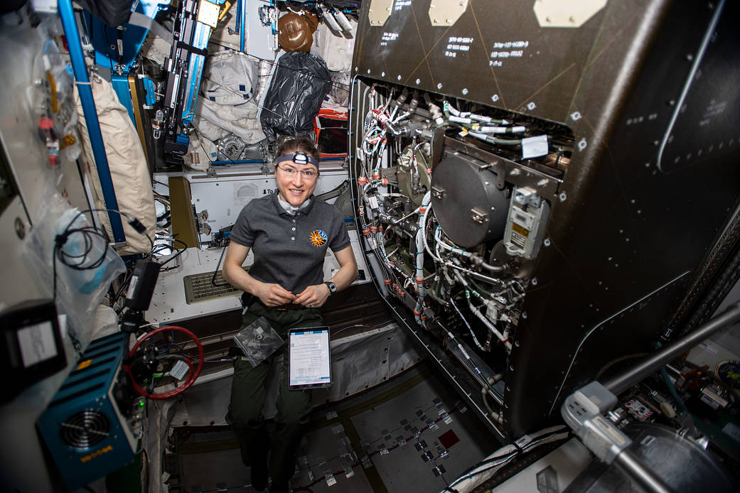 NASA astronaut Christina Koch works on orbital plumbing tasks