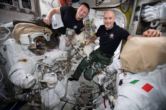 Astronauts Andrew Morgan and Luca Parmitano check U.S. spacesuits