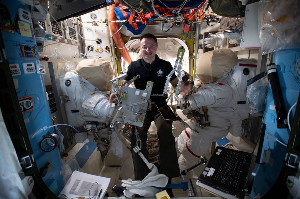 NASA astronaut Andrew Morgan checks specialized spacewalking tools