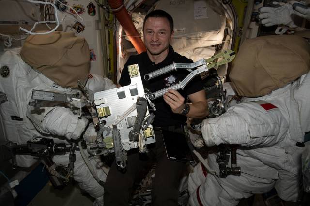 Astronaut Andrew Morgan checks specialized spacewalking tools