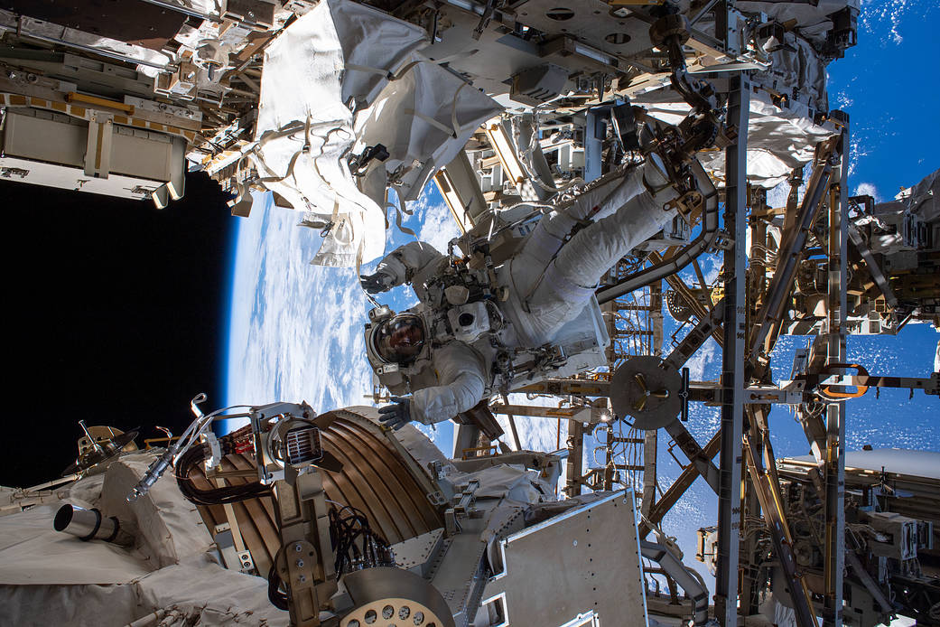 NASA spacewalker Andrew Morgan camouflaged by station hardware