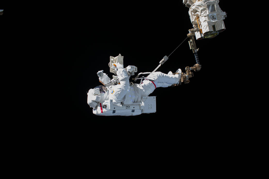 Spacewalker Luca Parmitano rides the Canadarm2 robotic arm