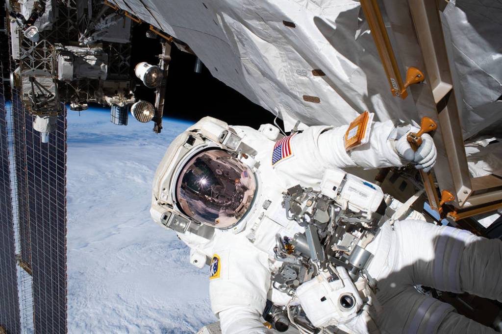Astronaut Andrew Morgan holds on to a handrail