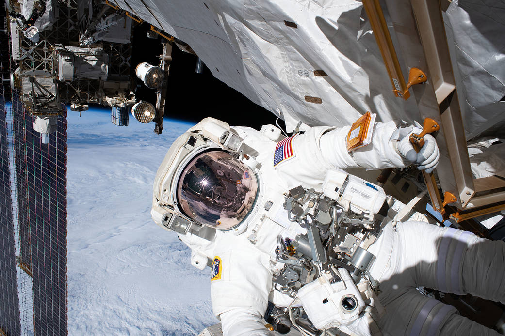 Astronaut Andrew Morgan holds on to a handrail