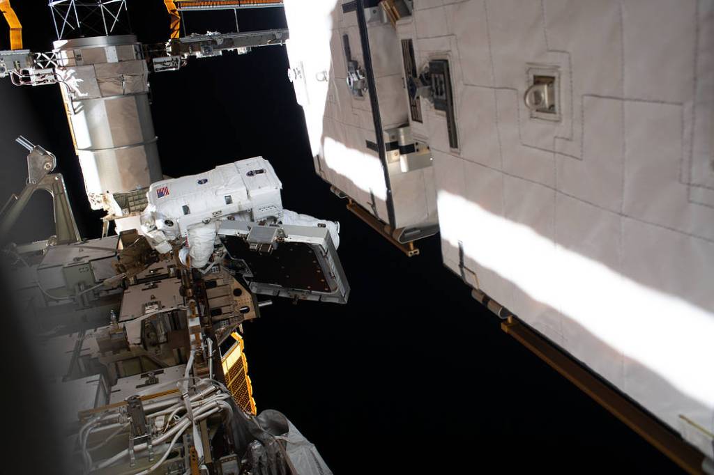 Astronaut Christina Koch is pictured near a solar array