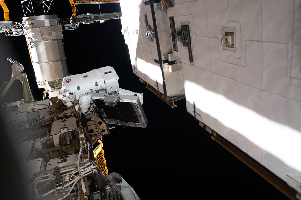 Astronaut Christina Koch is pictured near a solar array