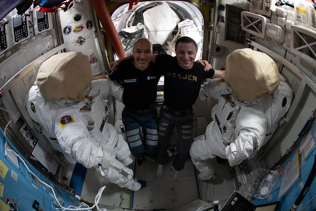 Astronauts Luca Parmitano and Andrew Morgan work on U.S. spacesuits