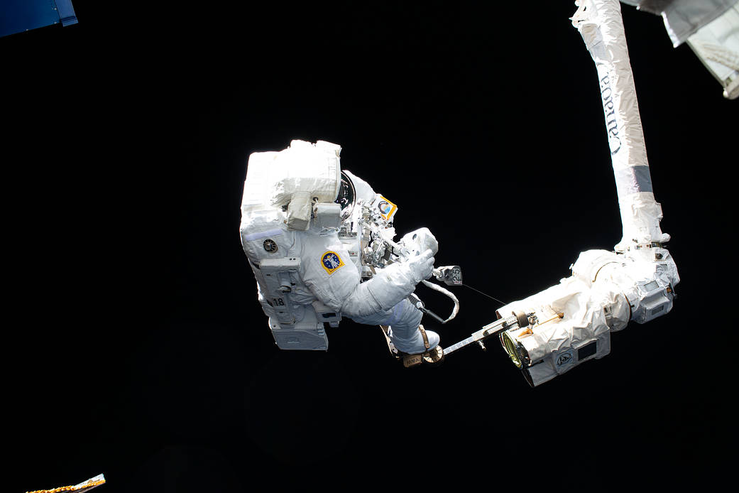 ESA astronaut Luca Parmitano is attached to the Canadarm2 robotic arm