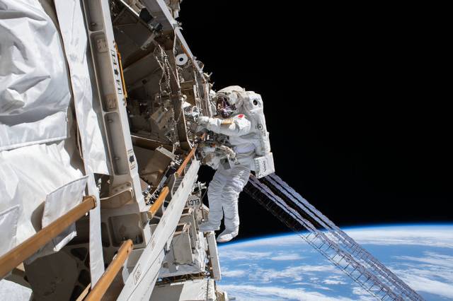 ESA astronaut Luca Parmitano is tethered to the space station