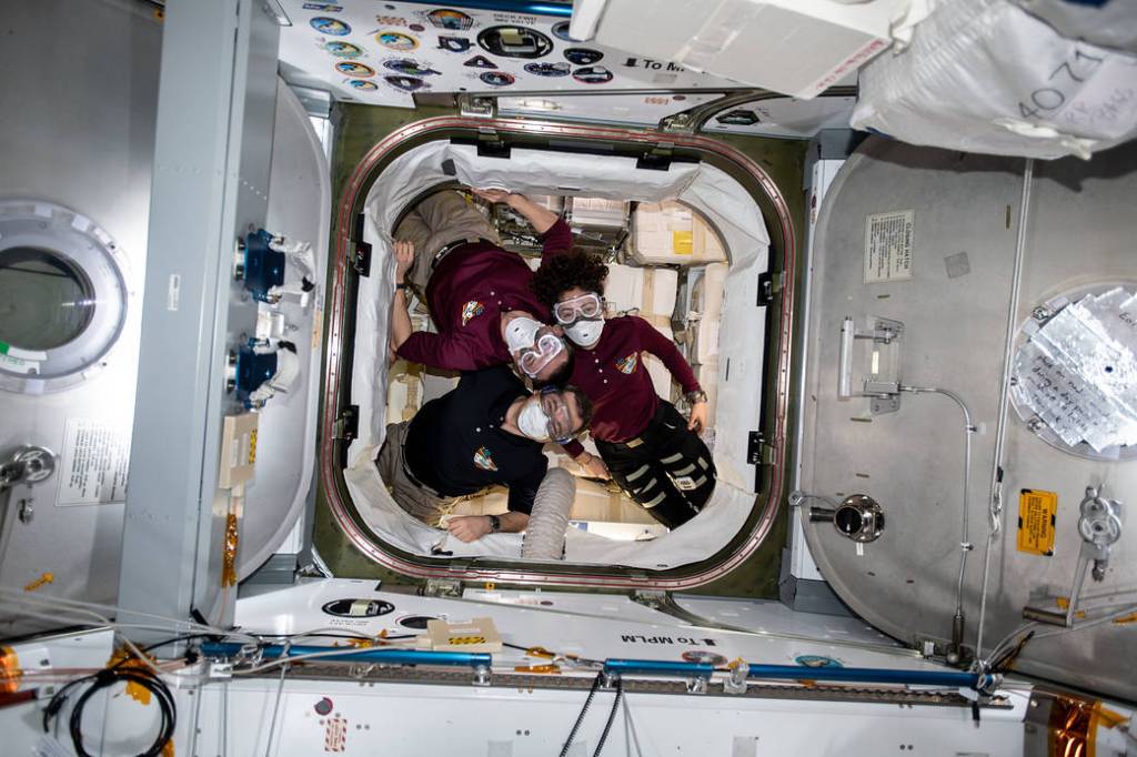 Expedition 62 crewmembers inside the SpaceX Dragon resupply ship