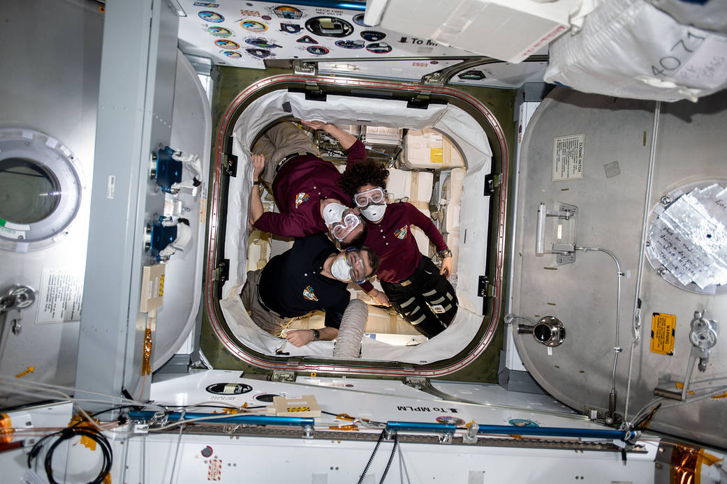 Expedition 62 crewmembers inside the SpaceX Dragon resupply ship