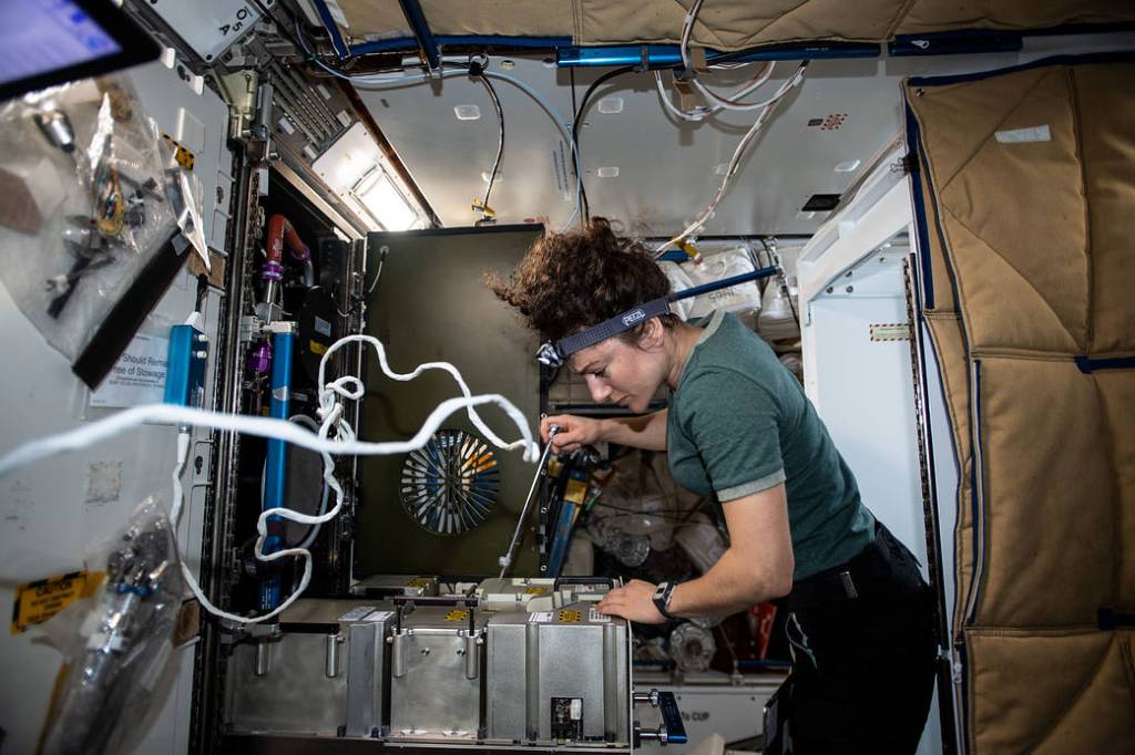 NASA astronaut Jessica Meir works on the Major Constituent Analyzer
