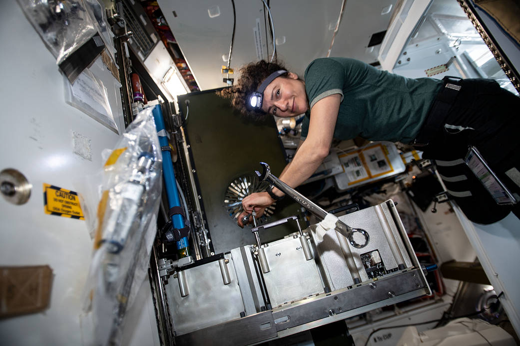 NASA astronaut Jessica Meir works on the Major Constituent Analyzer