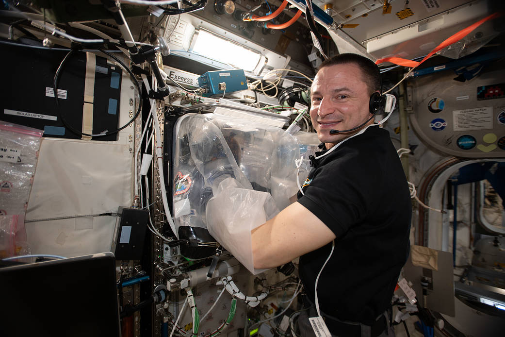 NASA astronaut Andrew Morgan services a 3D bioprinter