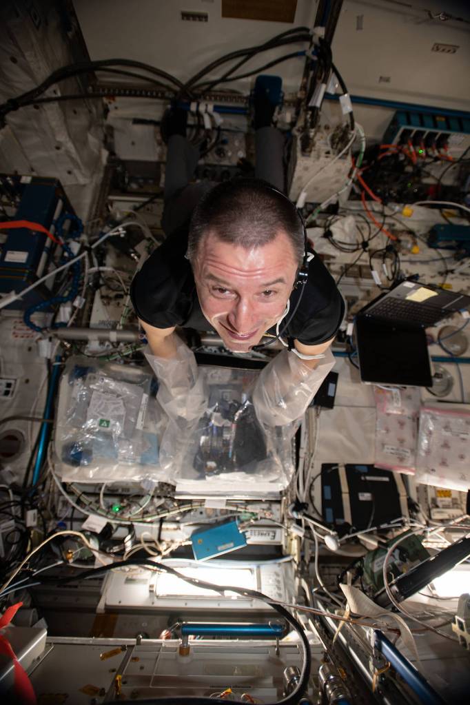 NASA astronaut Andrew Morgan services a 3D bioprinter
