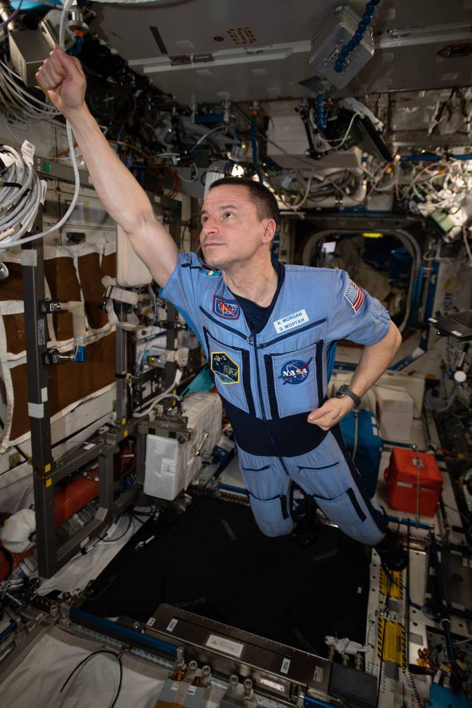 Expedition 62 Flight Engineer Andrew Morgan strikes a superhero pose