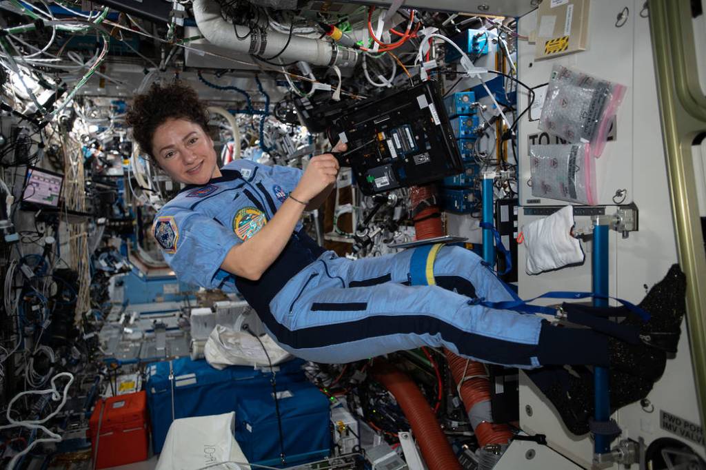 NASA astronaut Jessica Meir works on a laptop computer