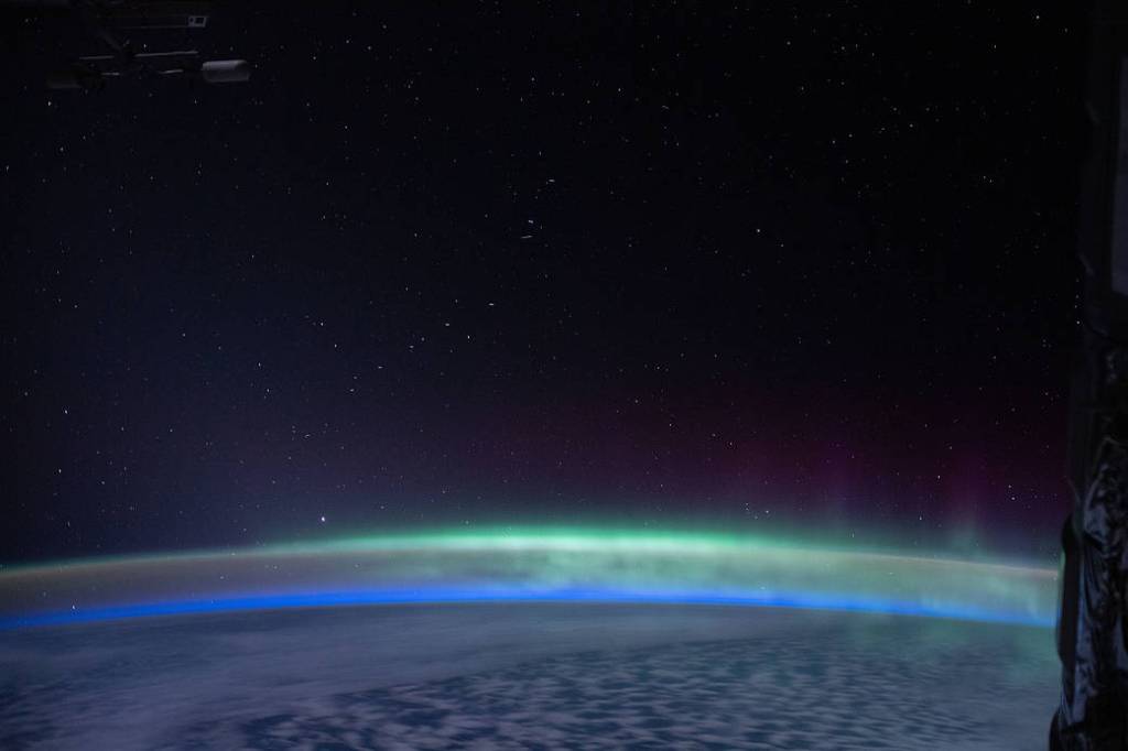 The Earth’s glow mingles with the “aurora australis”