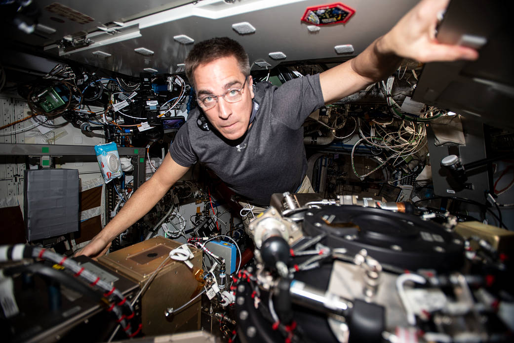 Expedition 63 Commander Chris Cassidy performs maintenance on the Combustion Integrated Rack
