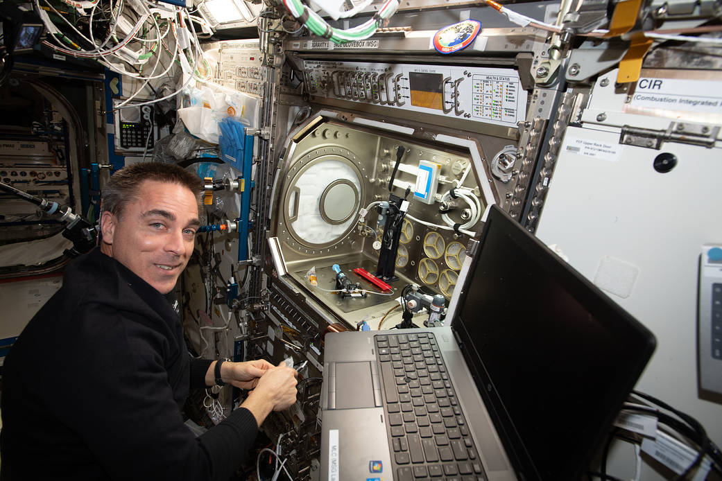 NASA astronaut Chris Cassidy sets up a space bubbles experiment